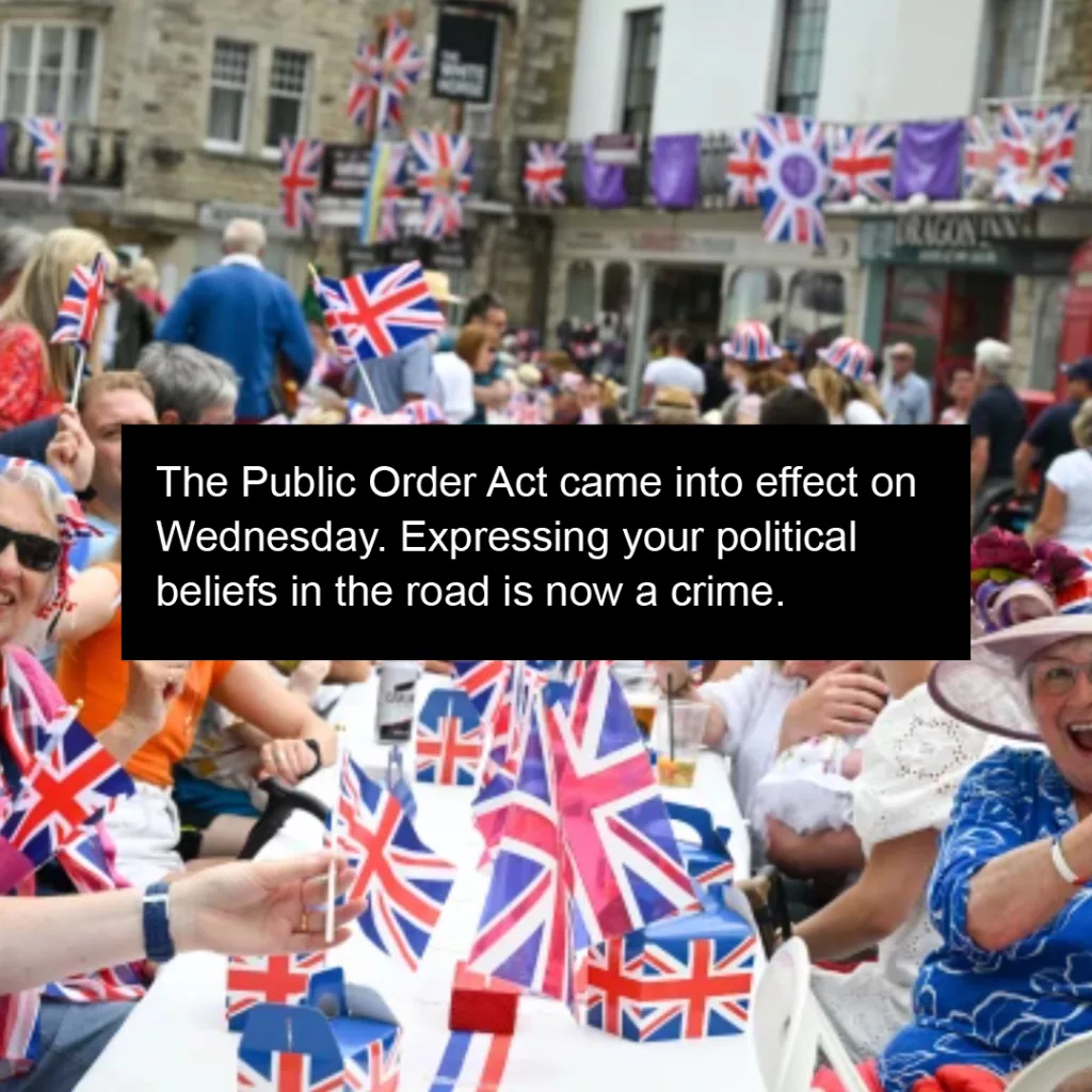 Crowds of people celebrating a patriotic event, decorated with british flags, sharing a convivial moment on a city street.